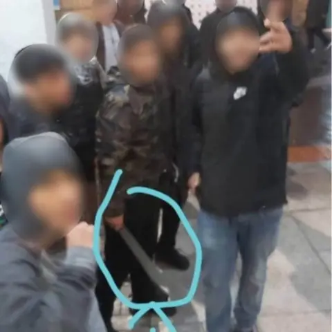 Twitter Boys holding a machete