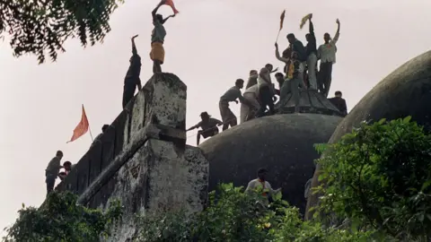 AFP In this file photograph taken on December 6, 1992 Hindu youths clamour atop the 16th century Muslim Babri Mosque five hours before the structure was completely demolished by hundreds supporting Hindu fundamentalist activists.