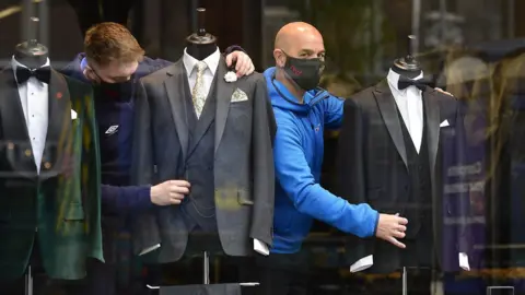 Pacemaker Shop attendants dress mannequins in Belfast suit shop