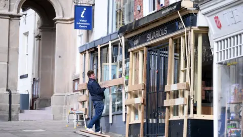 Getty Images Boarding up shops ahead of Shrove Tuesday Football in Ashbourne