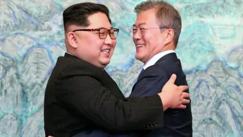 Getty Images North Korean leader Kim Jong Un (L) and South Korean President Moon Jae-in (R) pose (hug, hugging, hugs) for photographs after signing the Panmunjom Declaration for Peace, Prosperity and Unification of the Korean Peninsula during the Inter-Korean Summit at the Peace House on April 27, 2018 in Panmunjom, South Korea.