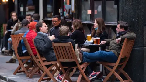 PA Media Photo dated 17 October 2020 of drinkers outside a pub in Soho, London, on the first day after the city was put into Tier 2 restrictions.