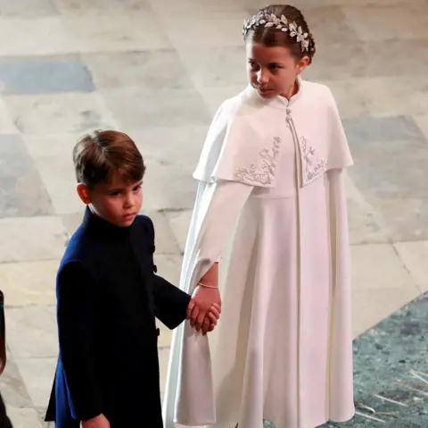 Reuters  Prince Louis and Princess Charlotte hold hands at Westminster Abbey