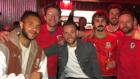 Matt Collins Matt with his friends alongside Wales players Tyler Roberts and Chris Gunter