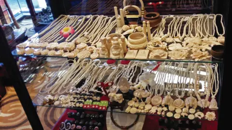 Lucy Vigne Ivory items on sale in a shop in Laos