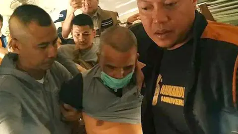 EPA Police officers arresting Somkid on the train