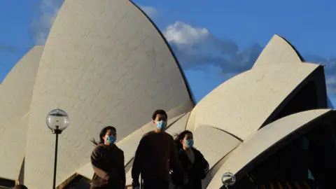 EPA People wearing masks outside the Sydney Opera House