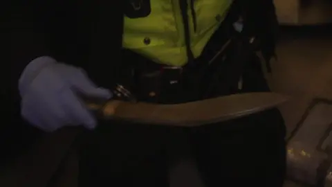 Police officer holding knife