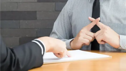 Getty Images Probation officer and offender sitting at table