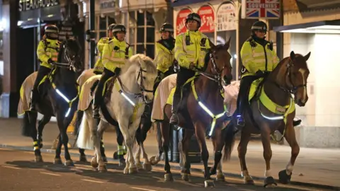 PA Media Mounted Police in Haymarket in London on New Year's Eve