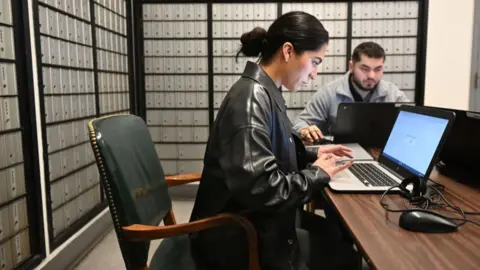 Getty Images A woman fills out a job application