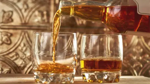 Getty Images whisky being poured from bottle