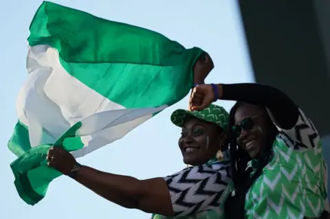 AFP Nigerian supporters cheer their team ahead of the 2019 Women's World Cup Group A football match between Norway and Nigeria, on 8 June 2019, in France.