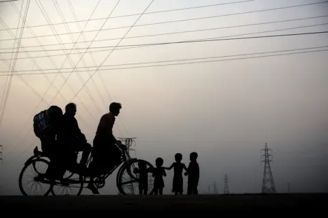 Getty Images Children playingon the outskirts of Dhaka