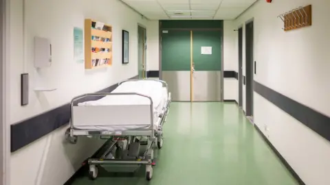 Getty Images Bed in a hospital corridor stock image