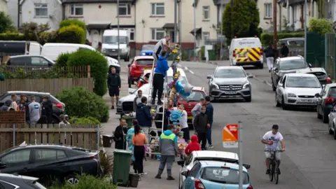 Getty Images Floral tributes being left in Ely, Cardiff