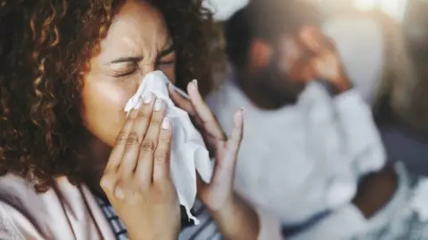 Getty Images Woman with flu