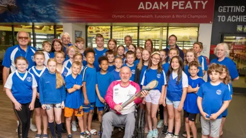 Getty Images Glyn Bennett takes part in The Queen's Baton Relay as it visits Uttoxeter as part of the Birmingham 2022 Queens Baton Relay on July 20, 2022 in Uttoxeter,