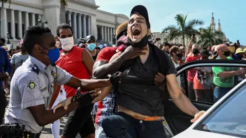 Getty Images A man is arrested during a demonstration against the government of Cuban President Miguel Diaz-Canel in Havana