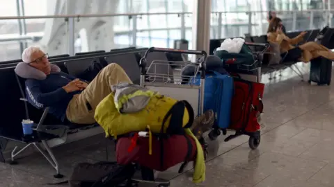 Reuters Sleepy passenger at Heathrow