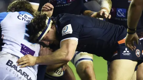 Hamish Watson makes a tackle during Edinburgh's win over Montpellier