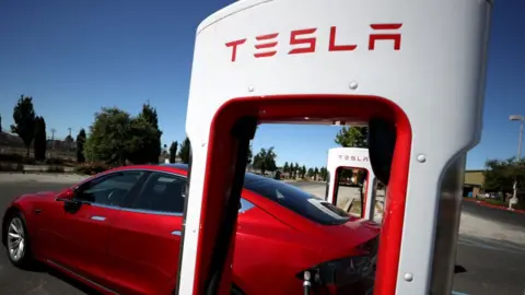 A stock photograph of a Tesla Supercharger in California