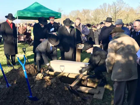 Remains of victims being buried