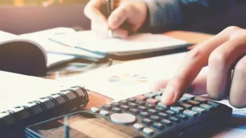 Getty Images Person using calculator