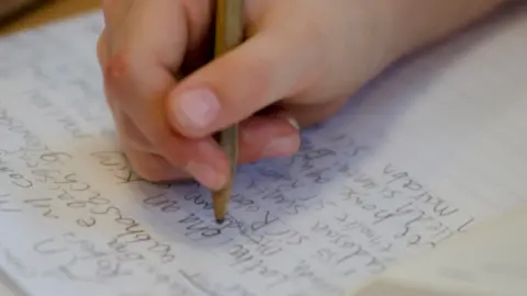 Getty Images Child writing