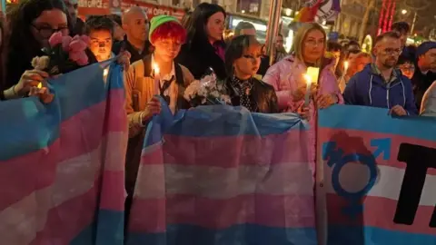 PA Media Members of the public attend a candle-lit vigil at the Spire on O'Connell Street in Dublin