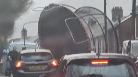 UGC Wind blows giant trampoline into road