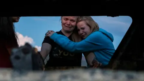 Getty Images Relatives mourning victims of the shooting