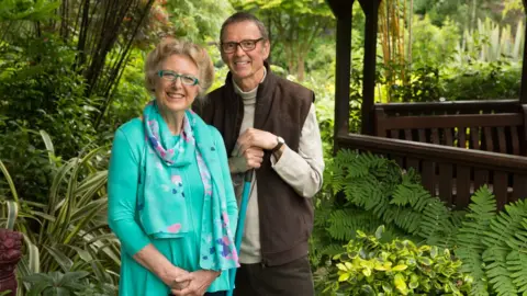 Tony Newton, Four Seasons Garden Marie and Tony Newton stood in their garden with lots of greenery surrounding them