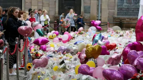 EPA Balloons and flowers at a makeshift memorial at St Ann"s Square