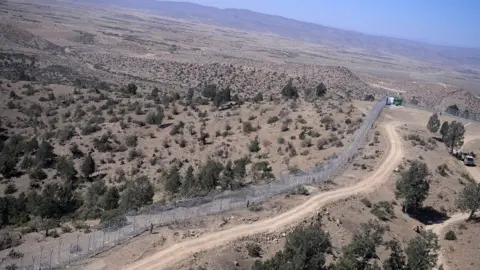 AFP/Getty Images Pakistani soldiers patrol next to a newly fenced border fencing along with Afghan's Paktika province border in Angoor Adda in Pakistan's South Waziristan tribal agency