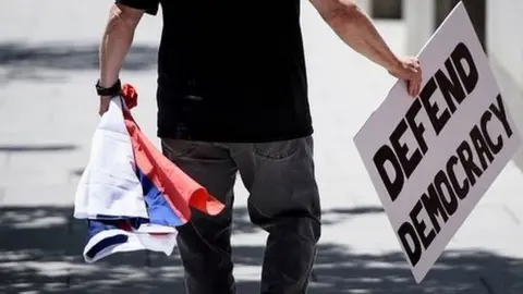 AFP Man with sign