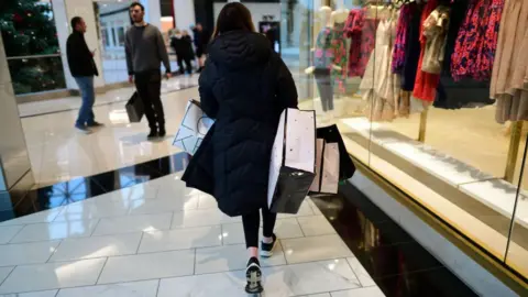 Getty Images A woman with shopping bags