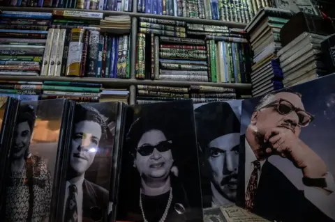 AFP Posters of famous Egyptian singers, actors and politicians are seen on sale at Cairo's historic al-Azbakeya book market at downtown in Cairo on January 16, 2019.