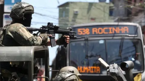 EPA Soldiers of the Brazilian Army patrol a street of the favela Rocinha, in Rio de Janeiro, Brazil, 10 October 2017.