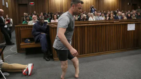 AFP Paralympic gold medallist Oscar Pistorius prepares to walk across the courtroom without his prosthetic legs during the third day of his hearing at the Pretoria High Court for sentencing procedures in his murder trial in Pretoria on 15 June 2016