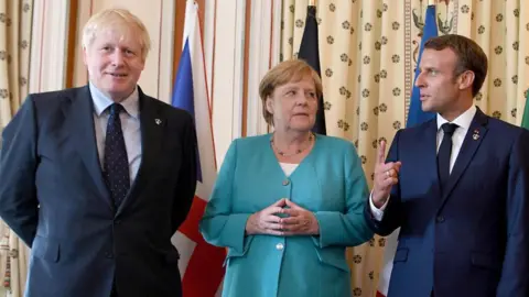 Getty Images Boris Johnson, German Chancellor Angela Merkel and French President Emmanuel Macron