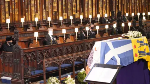 PA Media Queen Elizabeth II looks at the coffin of her husband the Duke of Edinburgh at St George's Chapel