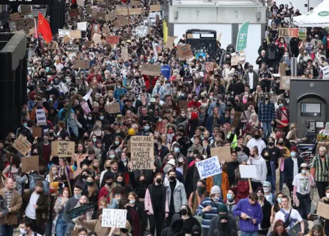 PA Media Thousands walk through the streets of Bristol