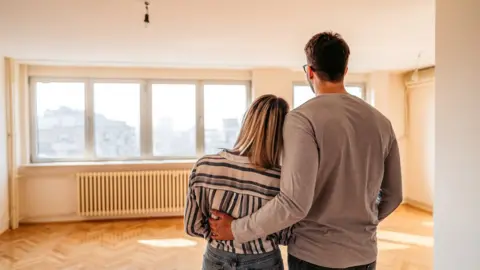 Getty Images Couple looking at new home