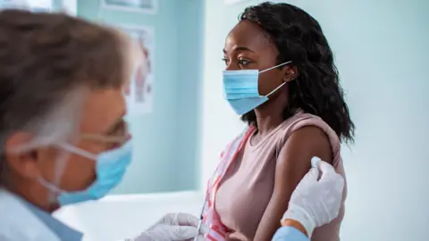 Getty Images Person getting vaccine