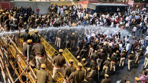 Getty Images Police are using water cannons to disperse Indian Youth Congress workers who are protesting in support of farmers in Jaipur, Rajasthan on 21 February.