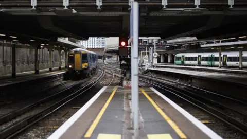 Tolga Akmen Train tracks with a train approaching in distance