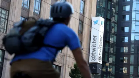 Getty Images A cyclist passes by the Twitter headquarters in San Francisco, California.