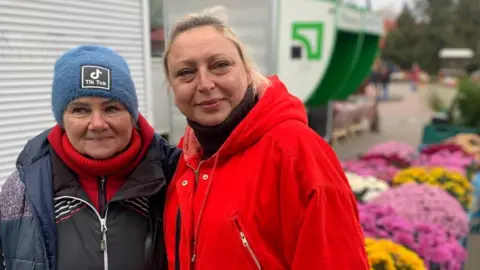 Kathy Long/BBC Tatiana and another woman stand in Kherson