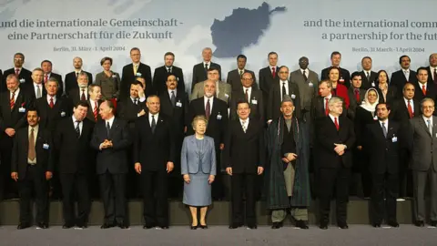 Getty Images Representatives from more than 60 countries pose for the family picture at the opening of the international conference in Berlin